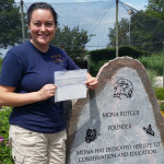 Photos of Heather holding donation check for Back to the Wild